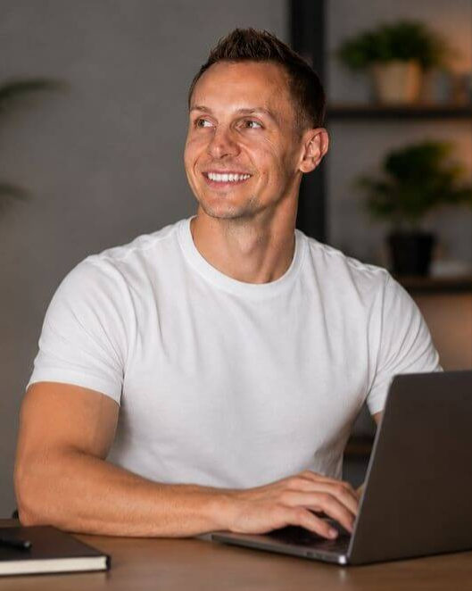 Mark Nicholson working at a laptop